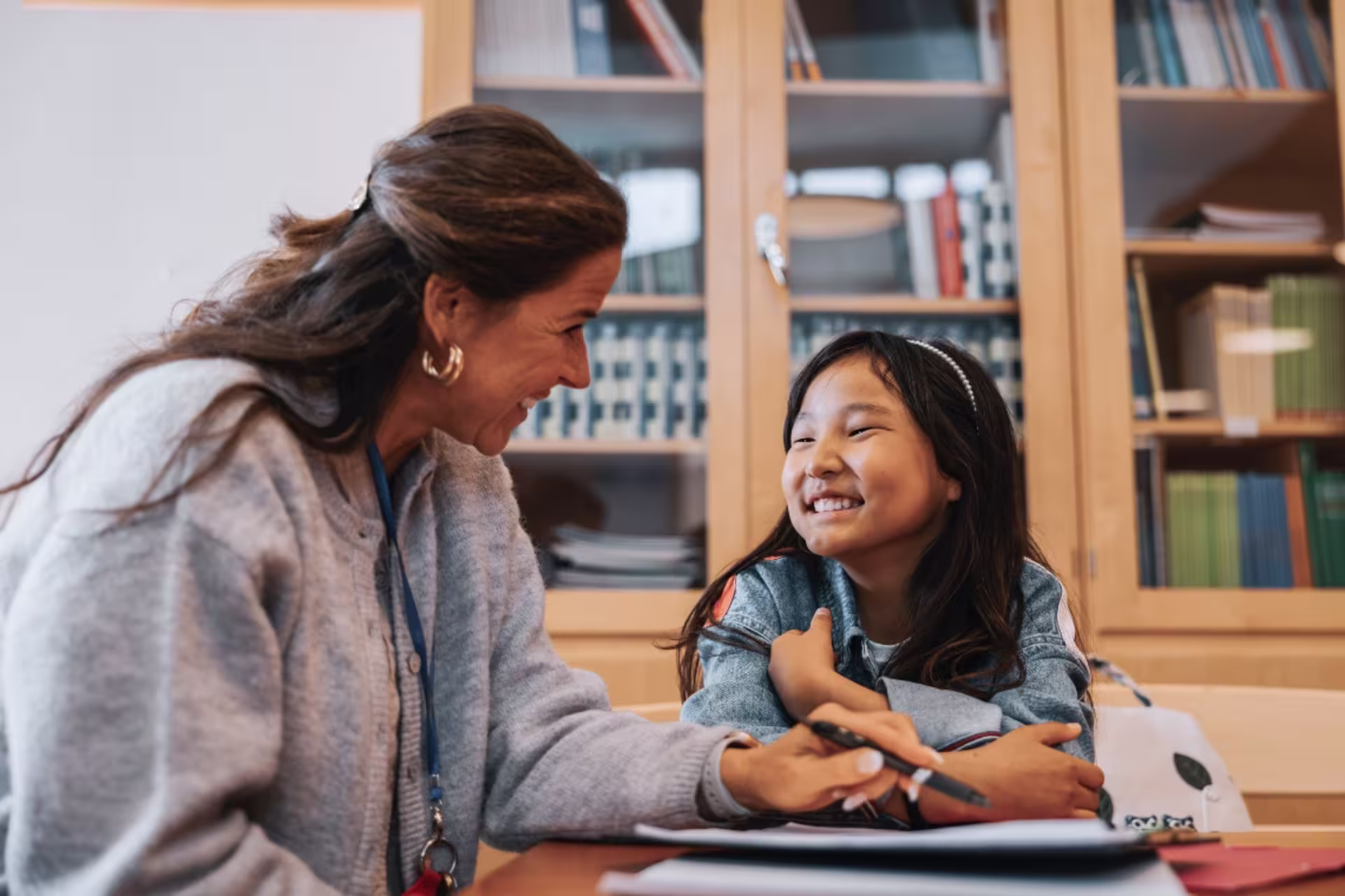 A school counselor speaks with an elementary student during a support session.