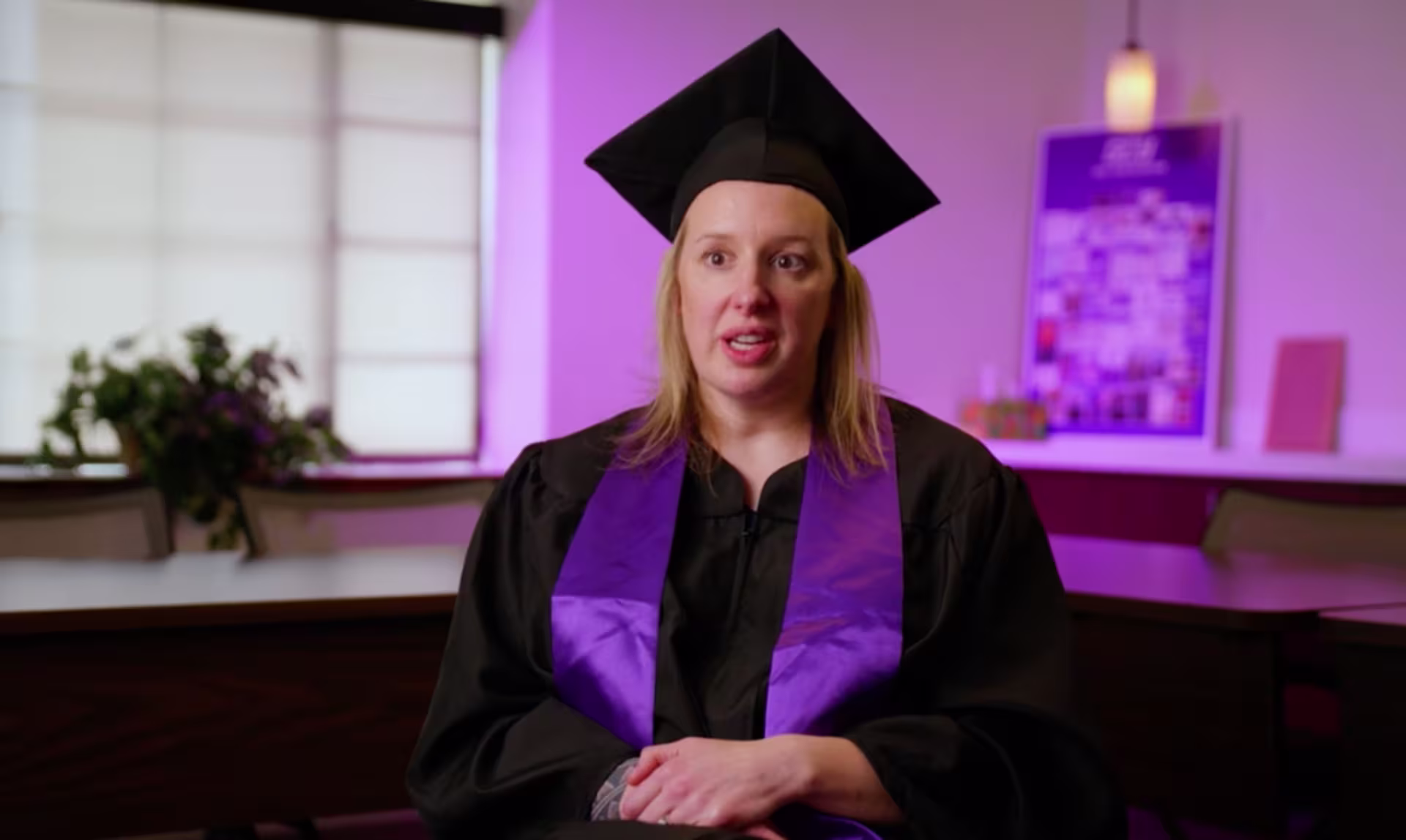 Rebekah Swindler, GCU RN-to-BSN graduate, talking to the camera in her graduation cap and gown