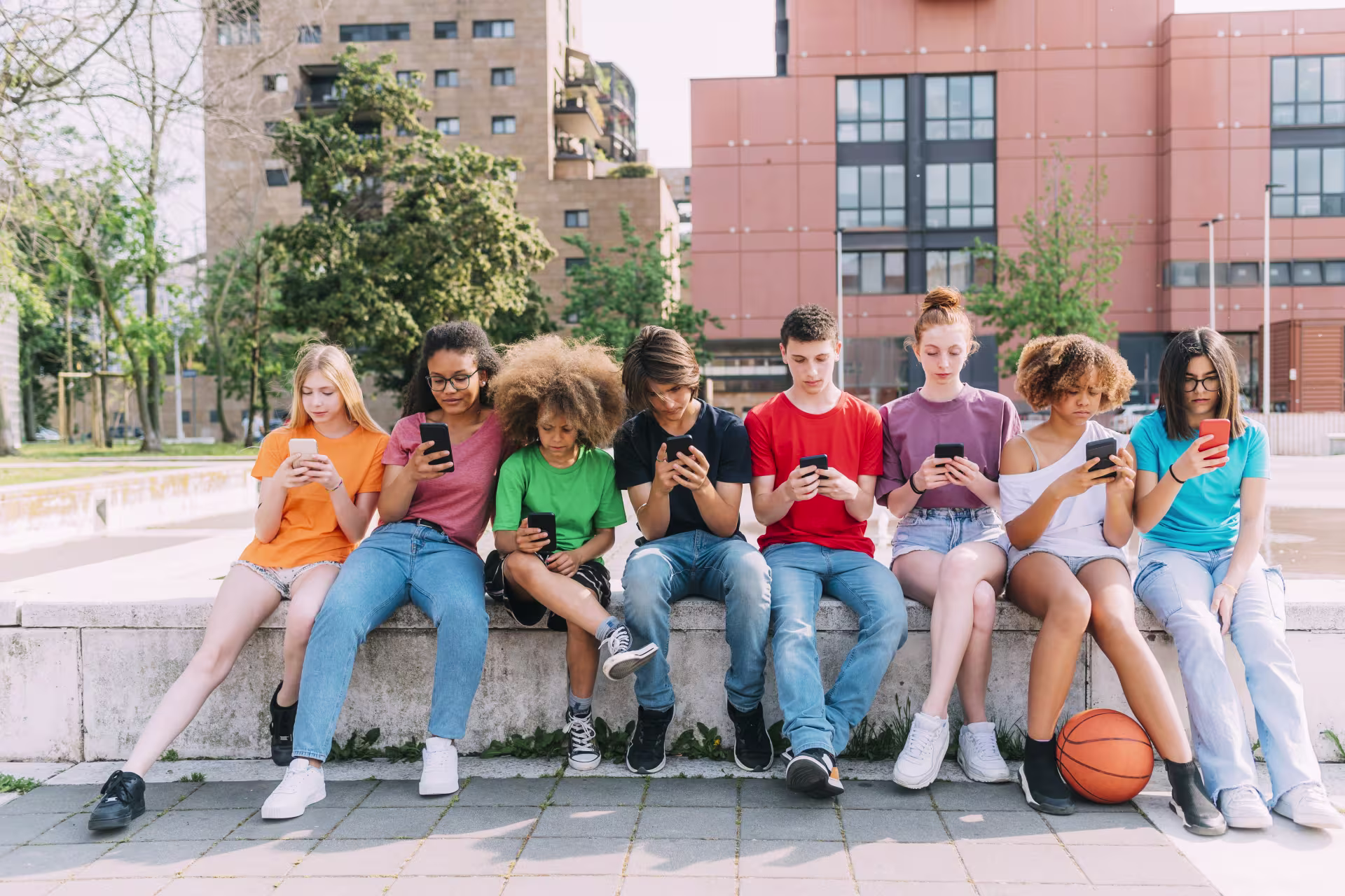 Group of teen friends using smartphones together.