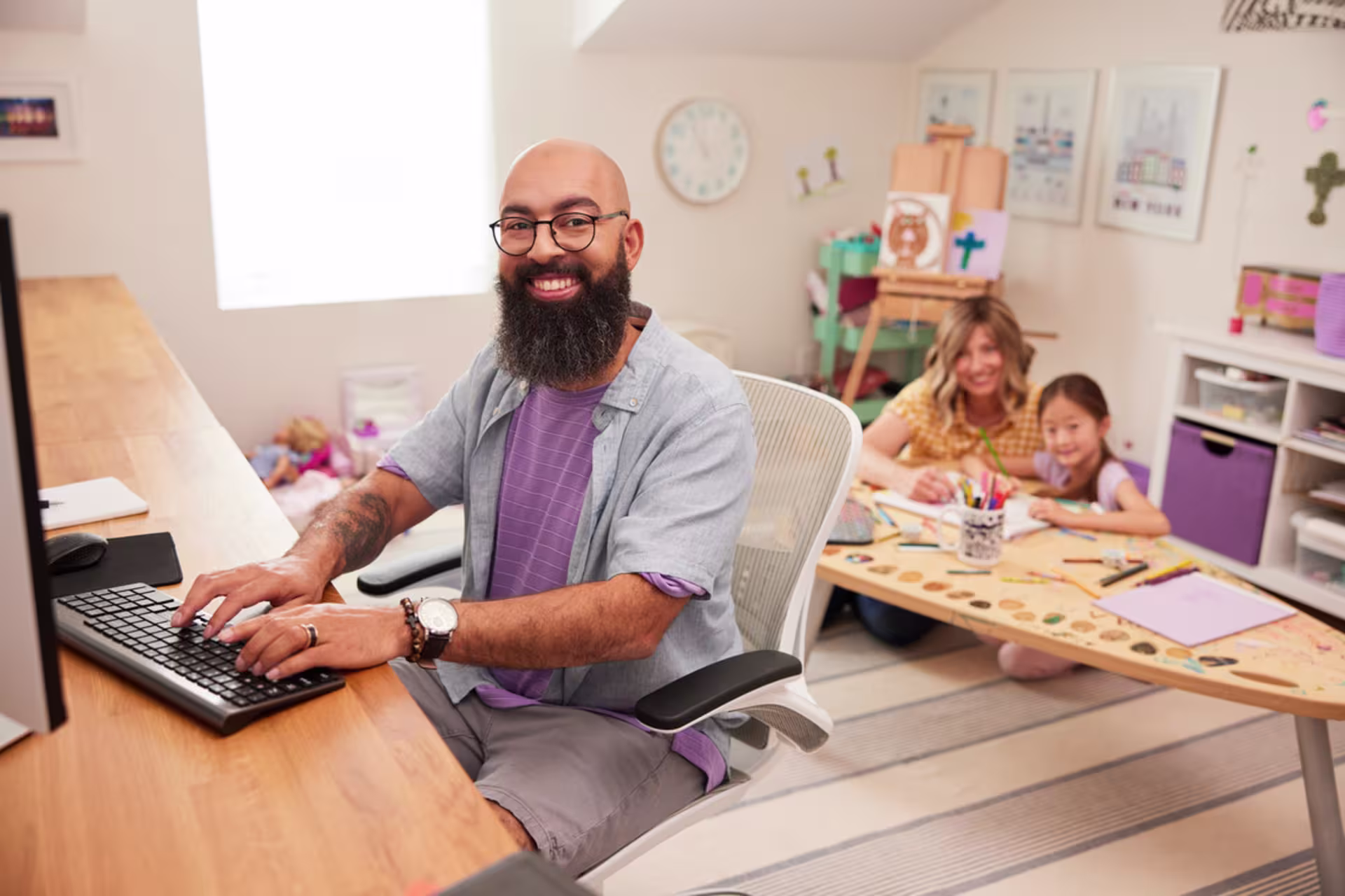 A professional works toward an online doctoral degree while studying from a home office.
