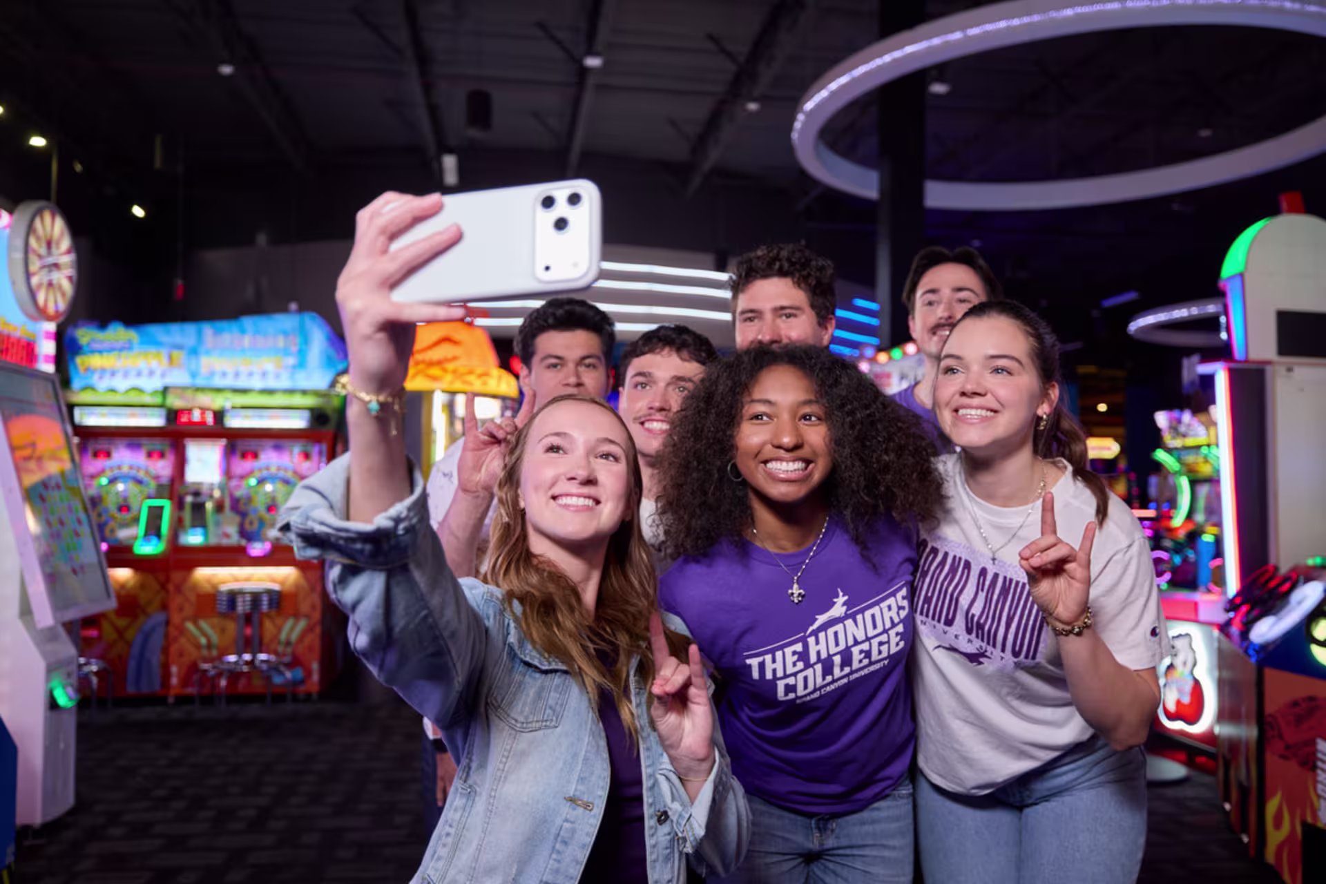 Social media degree students take a group selfie at a campus event.