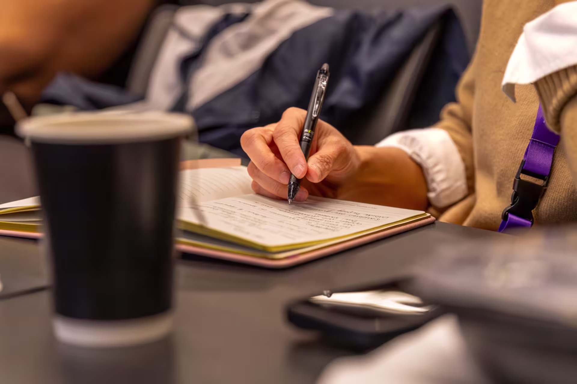An English and writing student takes notes during a class discussion.