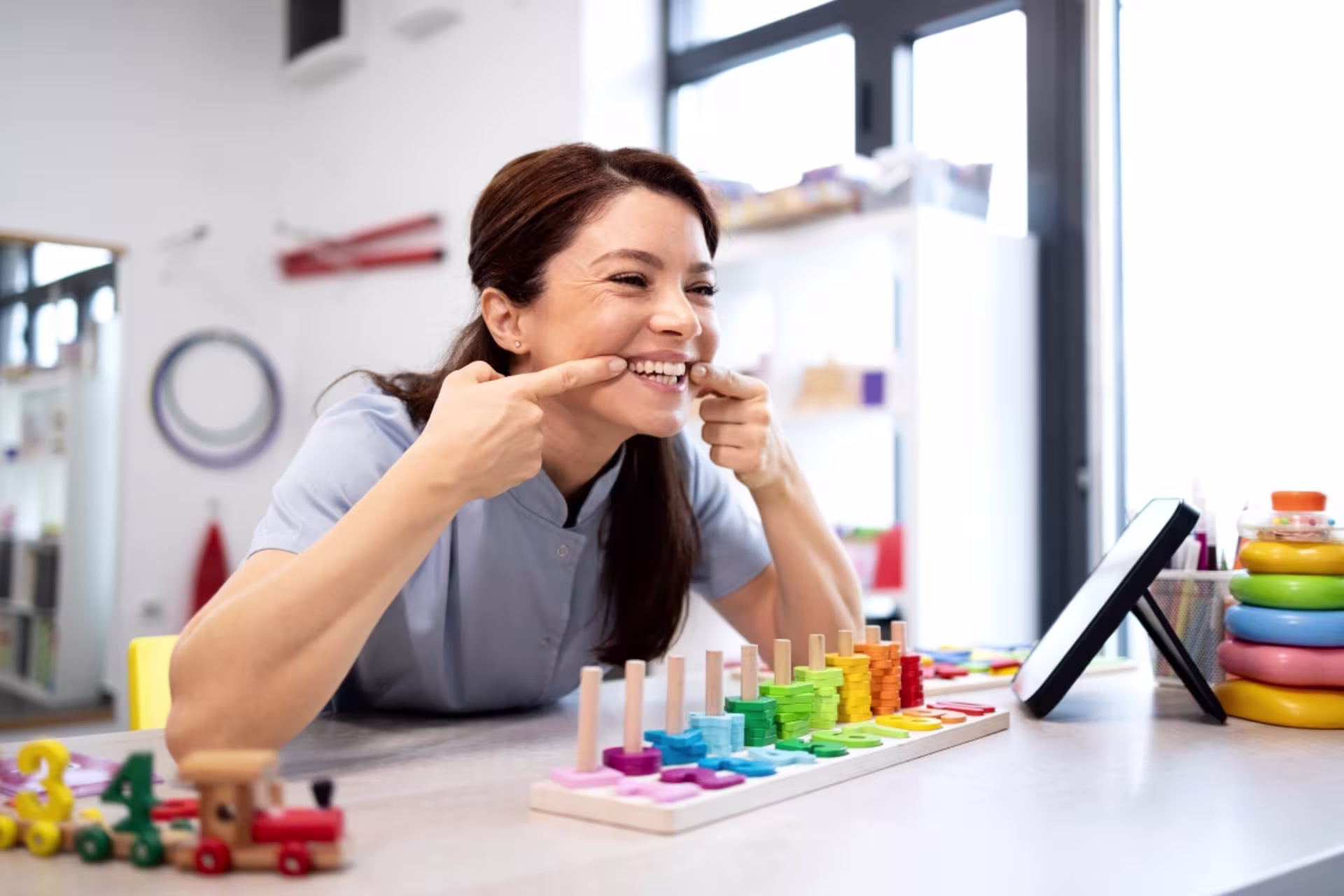 Female speech language pathology professional demonstrating a speech exercise.