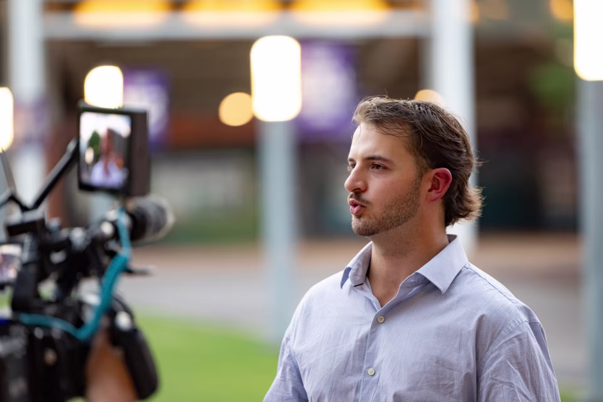 A male video editor speaks on camera during a video production.