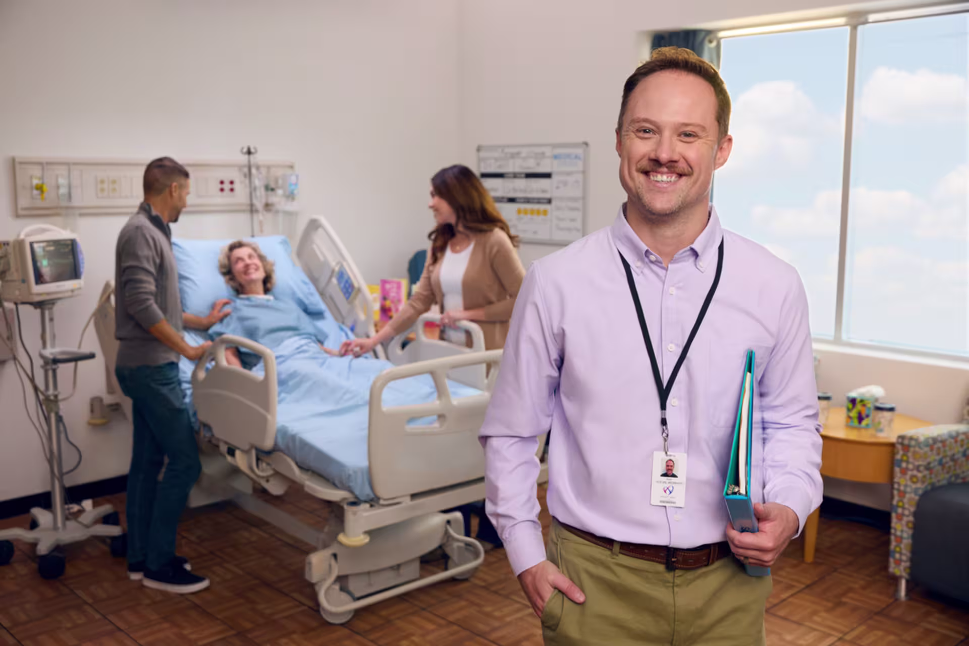 Male premed student gaining clinical experience in a hospital room.