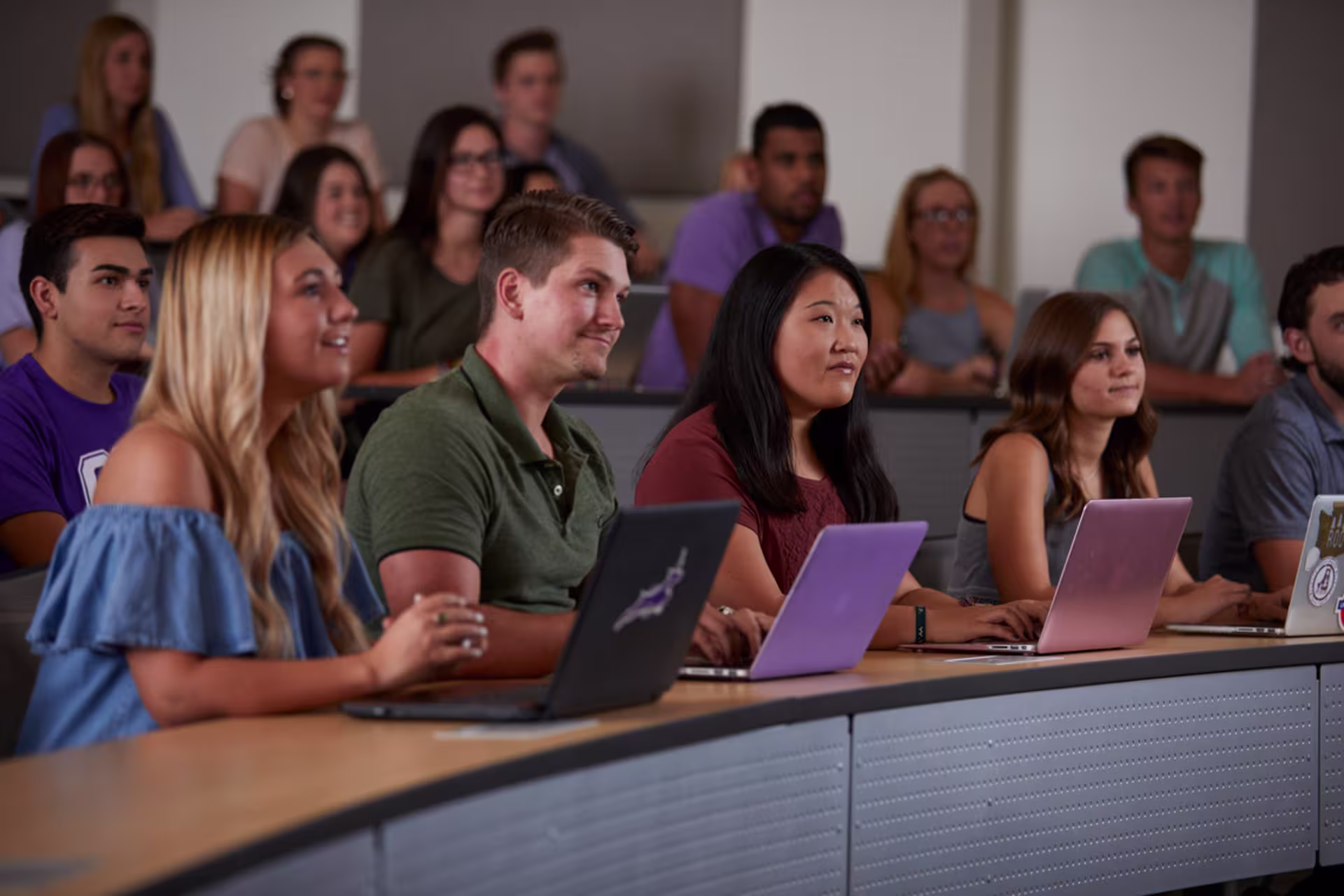 Students participate in an apologetics discussion while using laptops and engaging with course material.