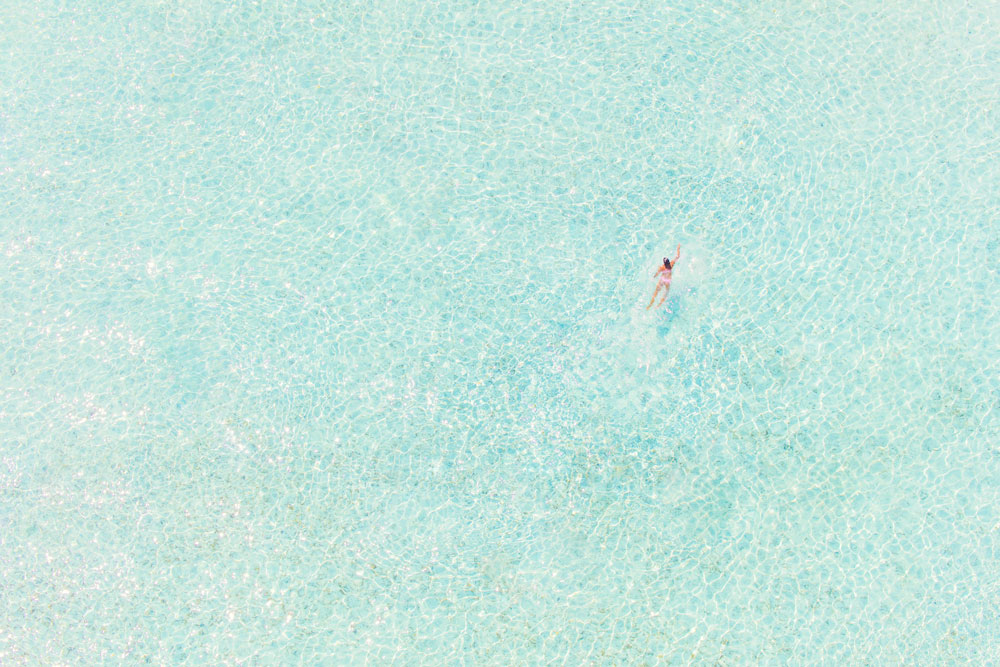 Girl in Pink, print by Gray Malin, part of his newest Bora Bora aerials collection