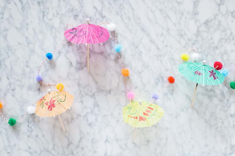 Gray Malin's umbrella pom pom garland