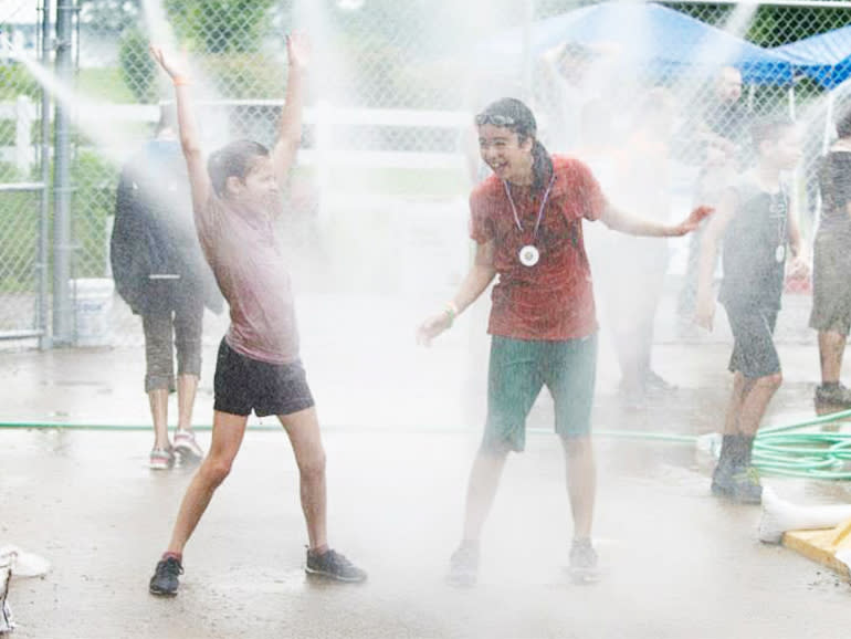 Kids enjoying the spray of water in the Kids wash