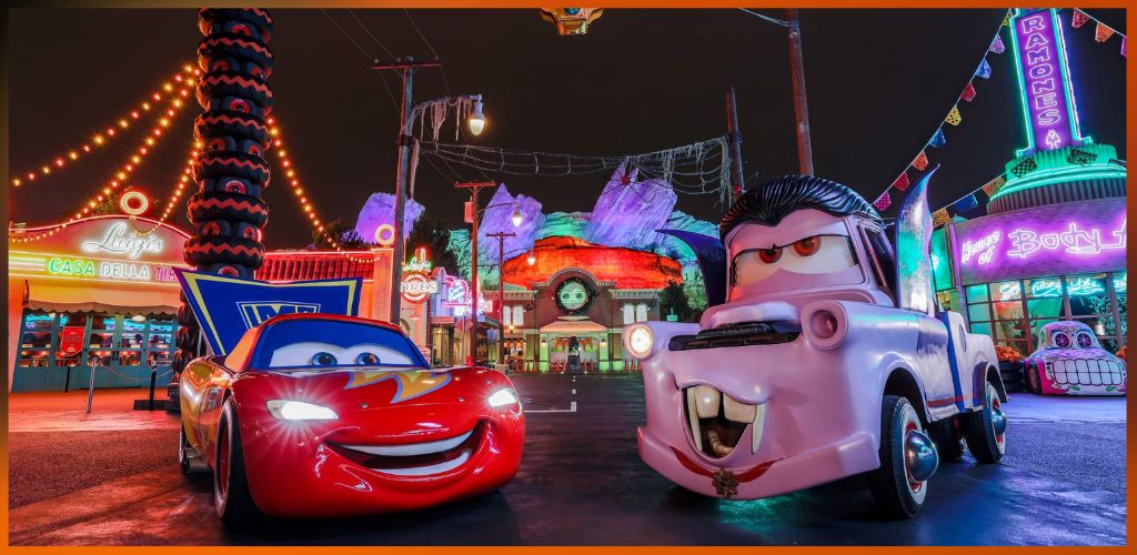 Colorful night scene with animated cars featuring expressive faces at an amusement park with bright lights and fun attractions.