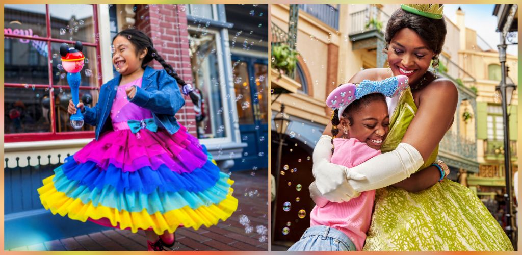 Two children smiling and playing outdoors, one holding a bubble wand and wearing a rainbow-colored dress, the other hugging a woman in a yellow dress with a hat.