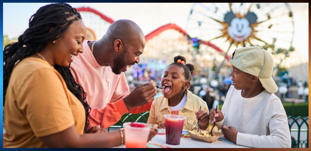 A family enjoying ice cream and food at an amusement park with a Ferris wheel and colorful attractions in the background.