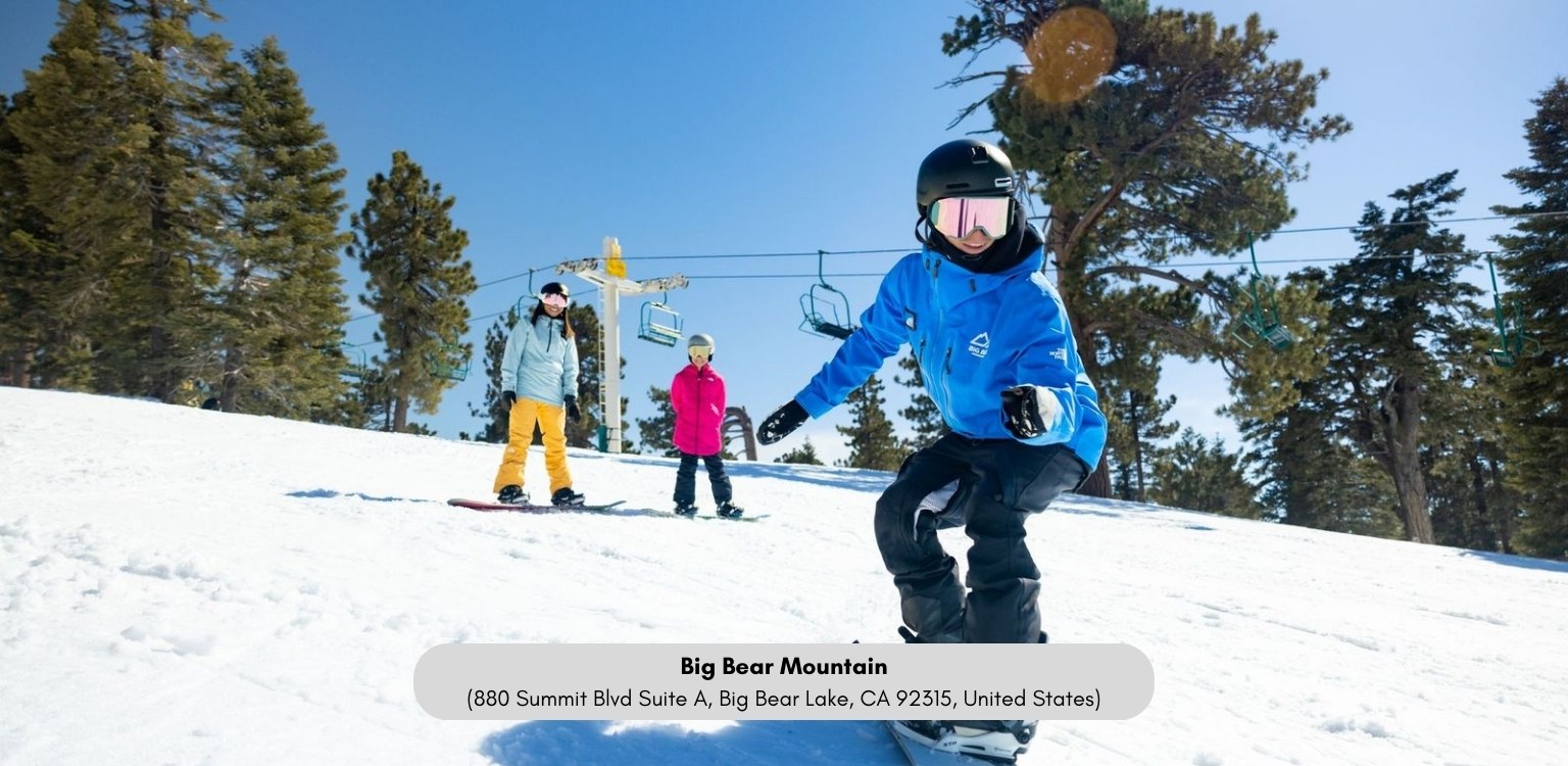 Children skiing on a snowy mountain with trees and ski lift in the background