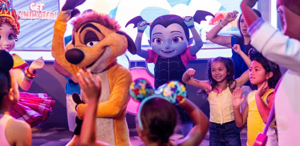 Children and adults interacting with colorful cartoon characters at a lively event indoors.