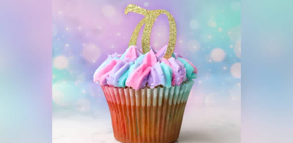 Colorful cupcake with pink and blue swirls of frosting, topped by a glittery gold number 70. The background is a dreamy mix of pastel colors, creating a festive atmosphere. Ideal for celebrating a milestone birthday in style.