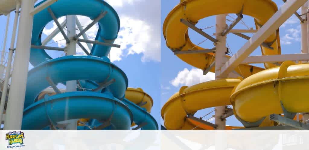 Two spiral water slides in blue and yellow under a partly cloudy sky.