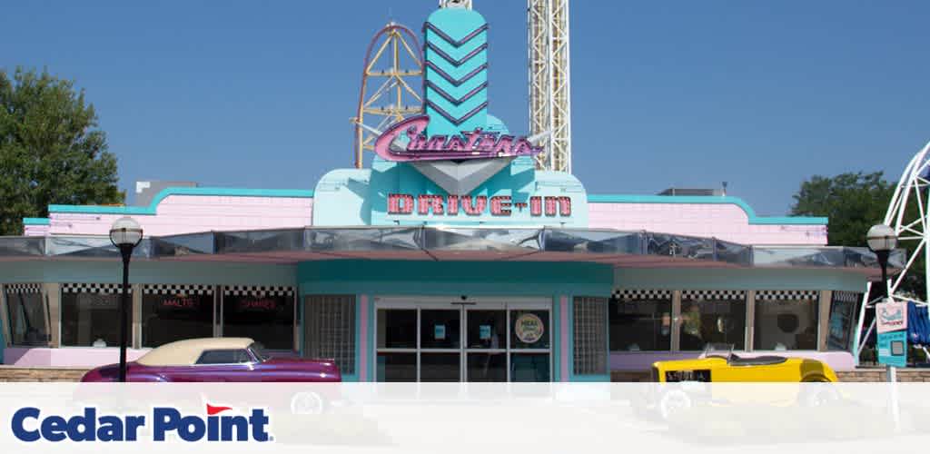 Retro-styled diner with pastel colors and vintage cars in front, at Cedar Point amusement park.