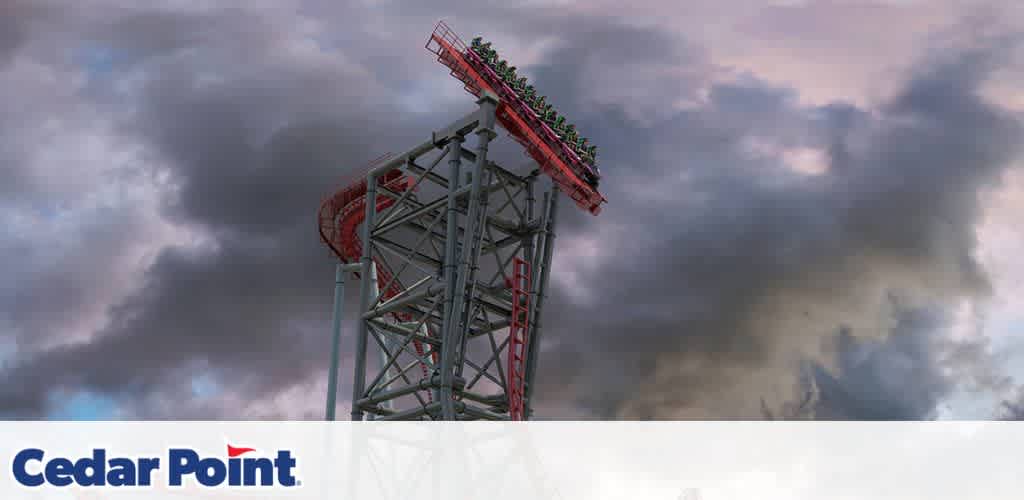 Roller coaster at the peak with a dramatic cloudy sky above.