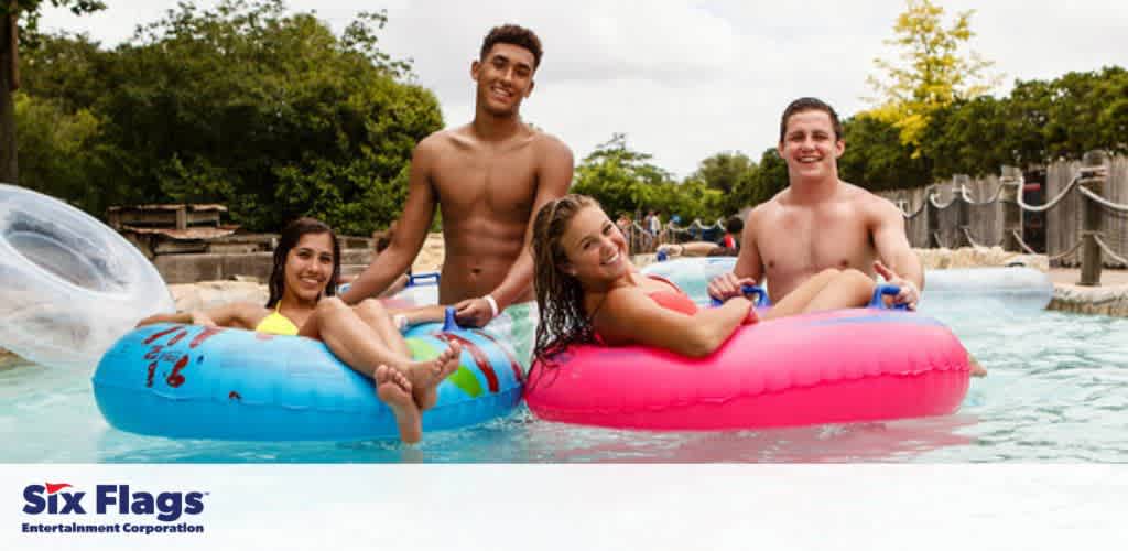 People on inflatable tubes floating in a lazy river at a water park.