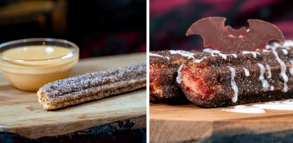 A chocolate churro with dusting sugar served with dipping sauce on a wooden board, adjacent to a chocolate-covered dessert topped with a chocolate bat decoration.