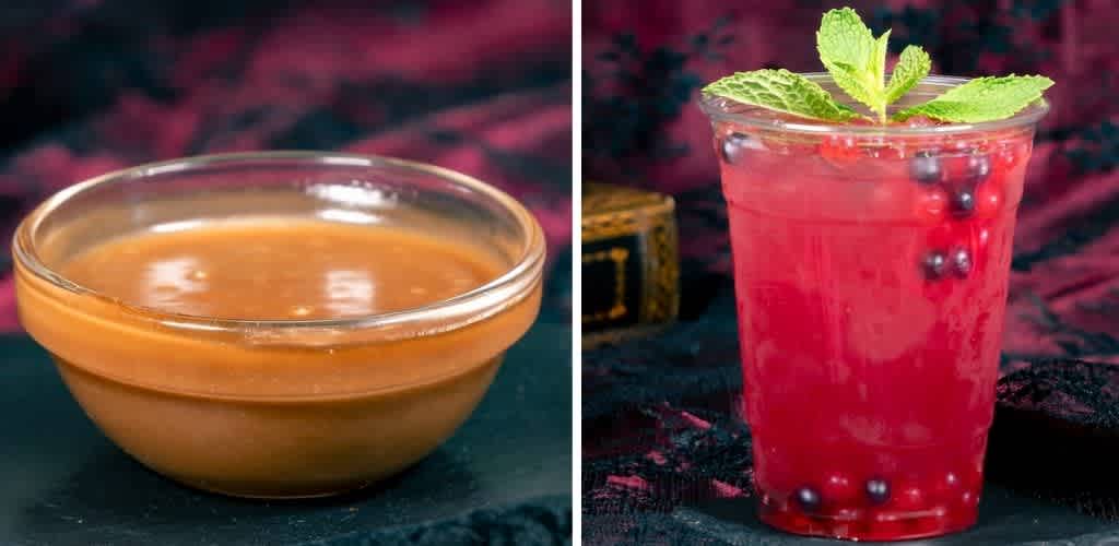 A bowl of caramel sauce next to a glass of berry cocktail garnished with mint and fresh berries