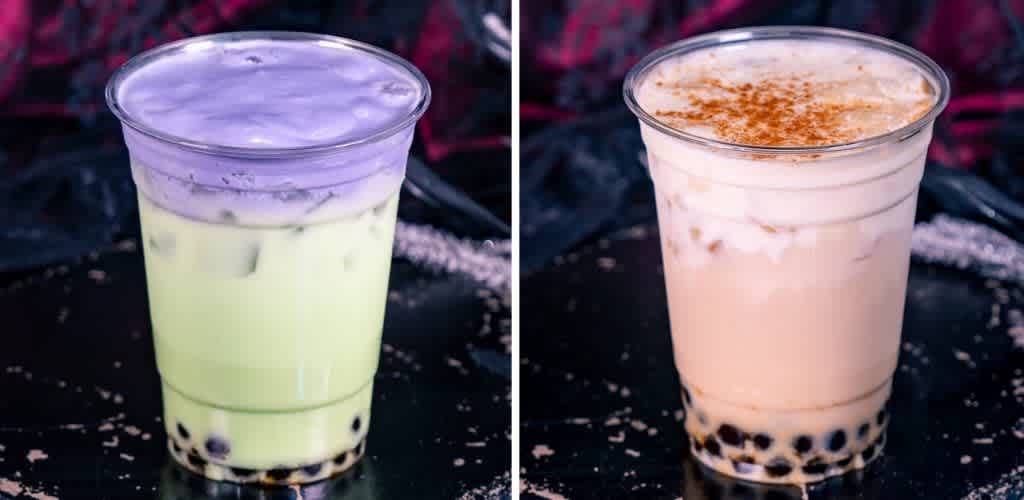 Two bubble tea drinks in clear cups, one with green tea and purple topping, the other with light pink tea and sprinkled cinnamon on top