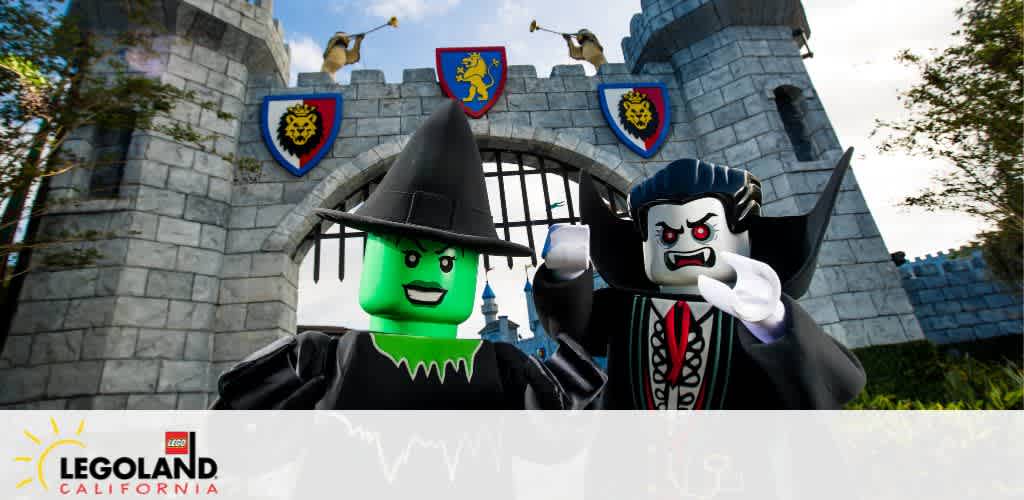 LEGO witch and vampire figures in front of a stone castle gate at LEGOLAND California.