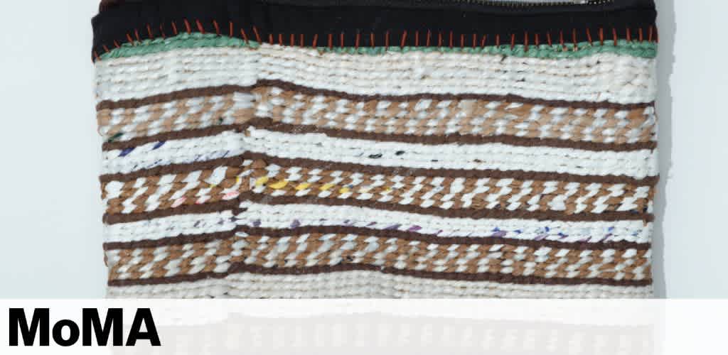 Woven textile pouch with brown and white stripes, featuring red and green stitching, and the word