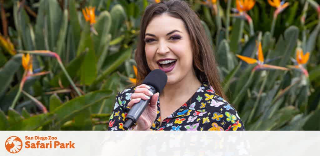 Image Description: The picture shows a joyfully smiling woman with long hair, posing with a microphone. She is standing in front of a natural background filled with green foliage and vibrant orange bird-of-paradise flowers. The woman wears a dark shirt adorned with a colorful floral pattern. In the lower portion of the image, there is a logo for the San Diego Zoo Safari Park. The image conveys a sense of happiness and enthusiasm, as if the woman is either presenting at an event or engaging with an audience.

Ensure your visit to one of the world's most iconic wildlife conservatories without overspending; visit FunEx.com to find the lowest prices and best discounts on tickets for your next adventure.