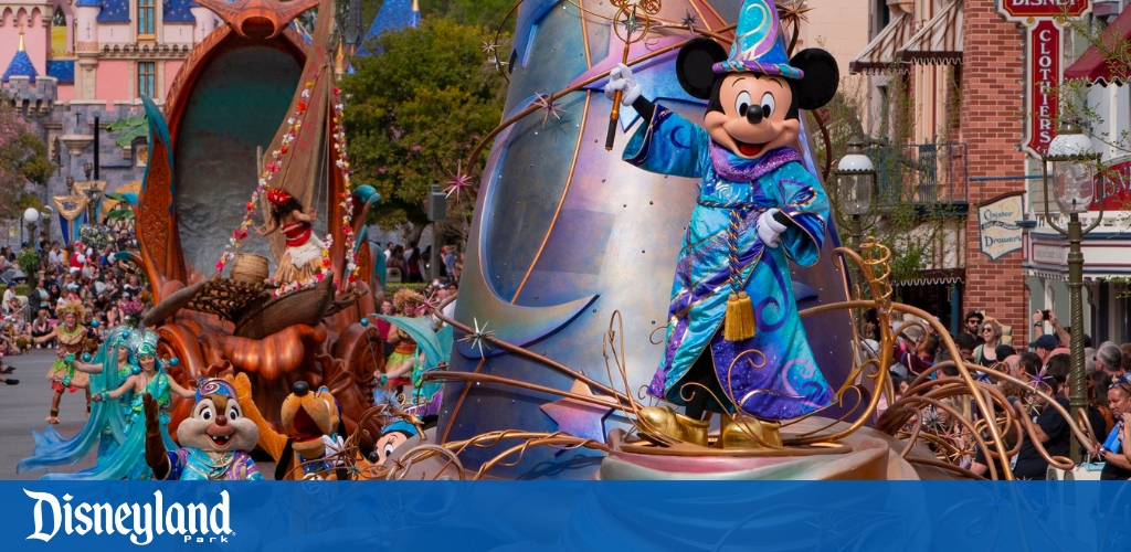 Mickey Mouse leads a colorful Disneyland parade on a festive float.