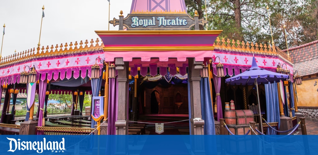 Colorful Disneyland Royal Theatre with curtains and regal decor.