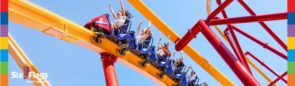 Image Description: This is a vibrant, action-packed photograph capturing a moment of exhilaration on a roller coaster at Six Flags Magic Mountain. In the foreground, a roller coaster car filled with overjoyed riders sweeps along a bright yellow and red track against a clear blue sky. The riders have their arms raised enthusiastically, showing a mixture of excitement and thrill. Directly below the coaster car, the support structure is painted a bold red, contrasting vividly with the yellow rails of the coaster track. The track loops and curves gracefully into the distance, illustrating the dynamic movement experienced on the ride. In the bottom left corner of the image, the Six Flags Magic Mountain logo is displayed, indicating the location of this entertainment venue.

To ensure you can experience the thrill of the ride without the worry of your budget, visit FunEx.com where you can find significant savings and the lowest prices on tickets to parks like Six Flags Magic Mountain.