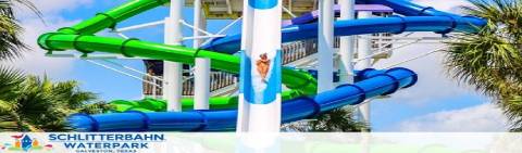 Image of Schlitterbahn Waterpark featuring a sunny sky background with a complex arrangement of intertwining water slides in blue and green. Palm trees flank the slides, enhancing the tropical atmosphere of the park.