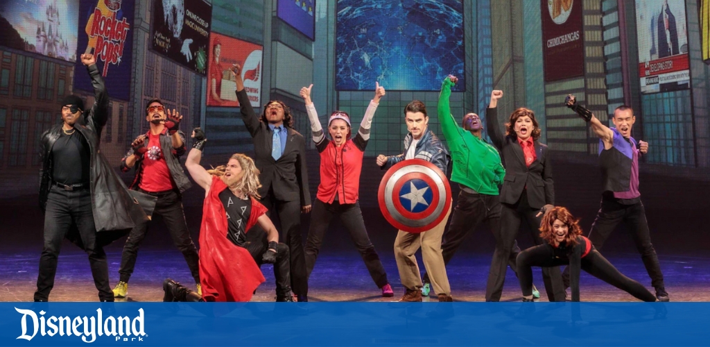 Performers on stage at Disneyland Park with superhero poses in a theatrical show.