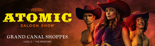 Promotional banner for Atomic Saloon Show at Spiegelworld. Features three performers in thematic costumes against a smoky red backdrop. Bold title in Western-style font. Show details include location at Grand Canal Shoppes, Level 2, The Venetian.