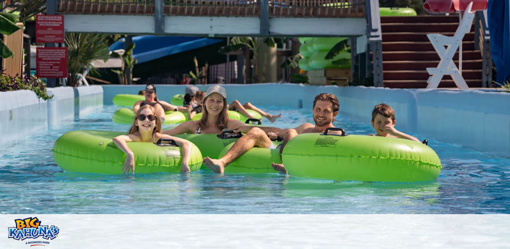 People in green tubes enjoying a lazy river ride.