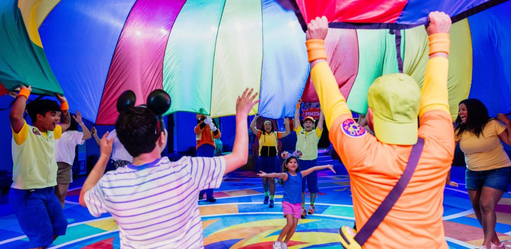 A group of children joyfully playing in a vibrant ball pit filled with colorful balls.