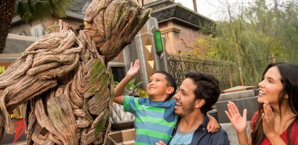A family interacting with Groot at Disney California Adventure Park in the Guardians of the Galaxy area.