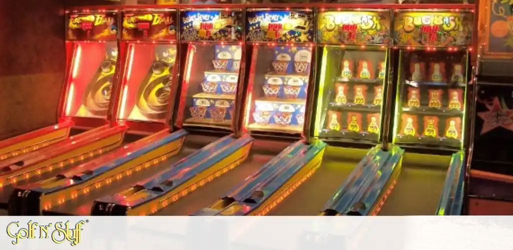 This image displays a vibrant and energetic scene from an arcade, featuring a row of colorful skee-ball machines. The machines are brightly lit, with warm tones dominating the setting. Each skee-ball lane is flanked by red, blue, and yellow neon stripes, leading up to the circular targets where players aim to score points. Above the lanes, digital scoreboards display various scores, alongside the names of the games such as "Ice Ball" and "Fever Pitch." The surrounding ambiance seems lively, suggesting that the arcade is a place of fun and entertainment. The flooring appears to be carpeted, adding to the indoor leisure environment.

Incorporate GreatWorkPerks.com into your next adventure for unbeatable savings on tickets! With our lowest prices guarantee, you'll enjoy every moment even more.