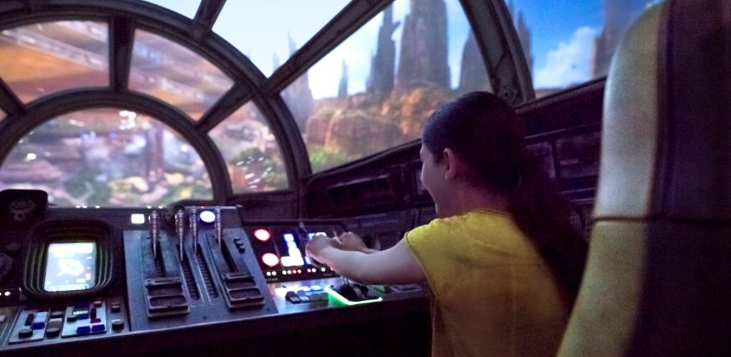 A guest piloting the Millennium Falcon on the Smugglers Run ride at Star Wars: Galaxy’s Edge in Disneyland.