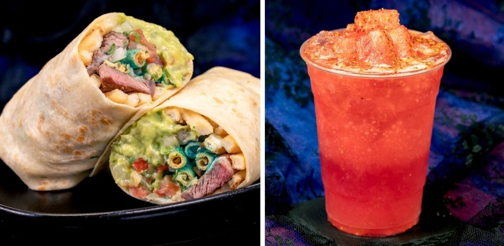 A burrito wrapped in a flour tortilla cut in half showing rice, lettuce, meat, and colorful toppings next to a red frozen drink with crushed ice on a dark background.