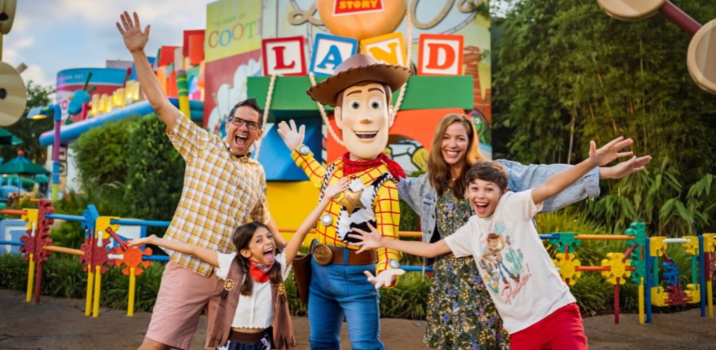 Smile of happy family with toy cowboy at Land of Fantasy amusement park outdoor area