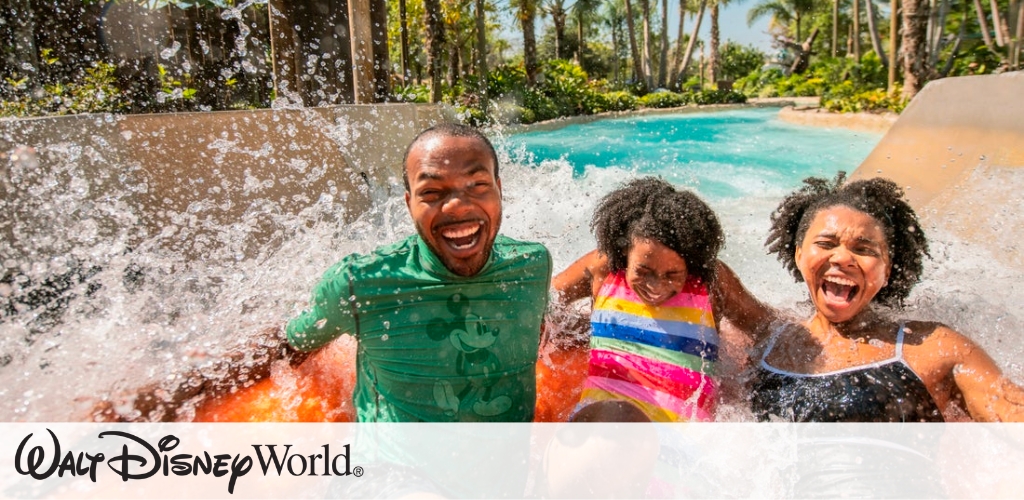 A family enjoys a thrilling water ride at a theme park, laughing as water splashes around them. Lush greenery and tropical trees surround the ride, creating a vibrant and fun atmosphere. Bright sunlight adds to the cheerful mood of the scene, capturing the excitement and joy of a day out at the park.