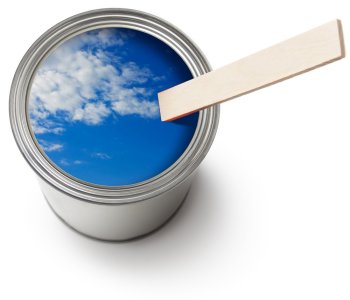 A beautiful blue sky is reflected in an open can of paint