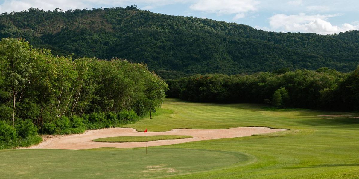 Fairway and sand bunkers at Kirimaya Golf Resort surrounded by green hills
