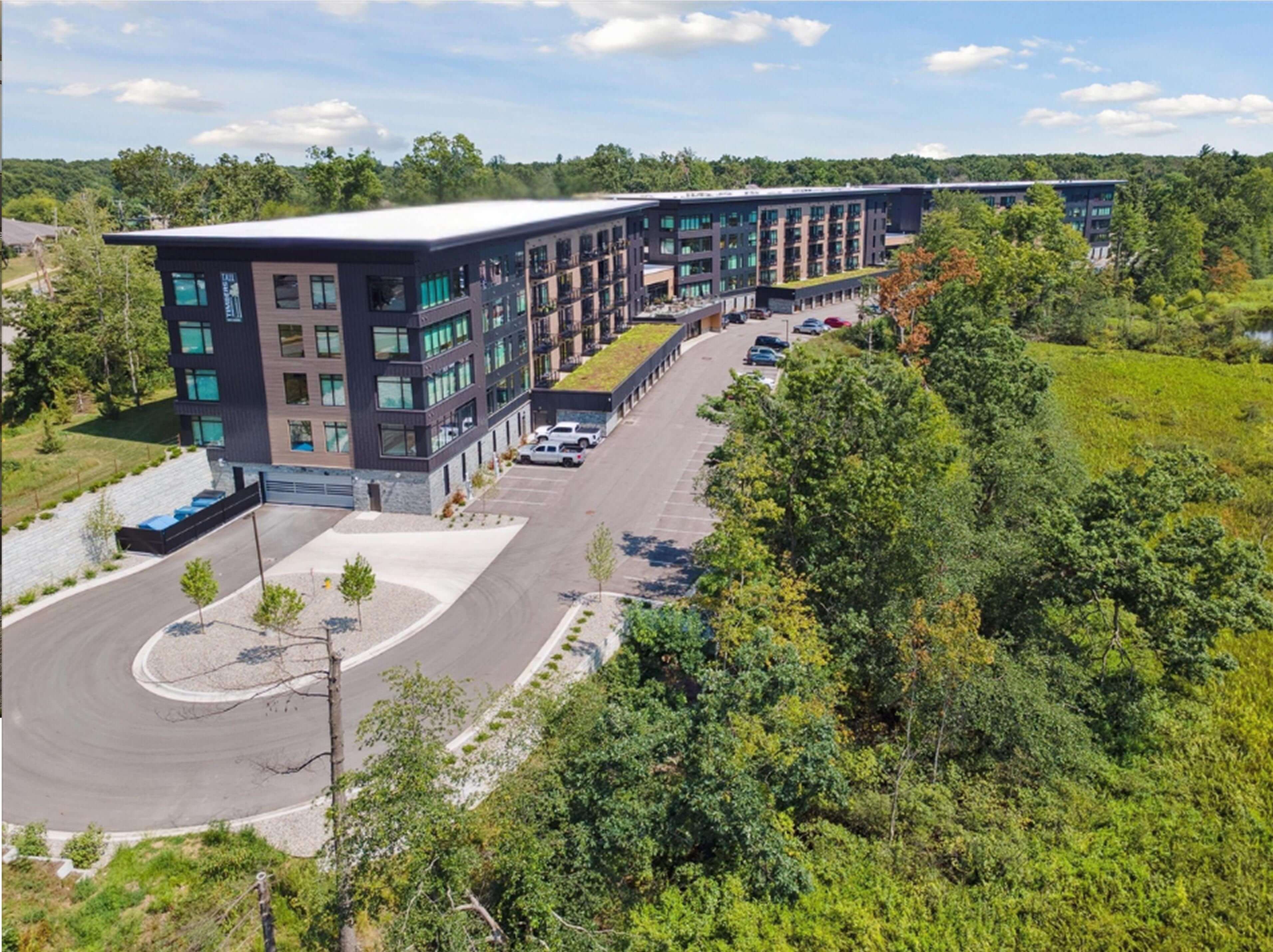 Tall Timbers 3D rendering of apartments and parking lot.