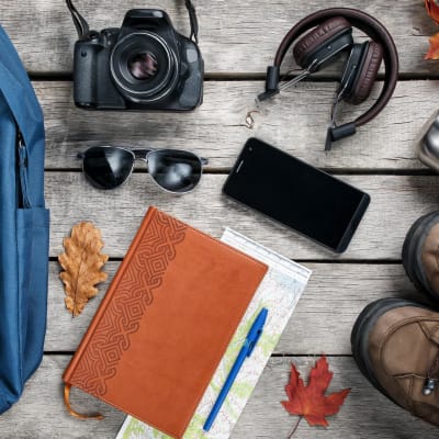  Ein Set Reisematerialien auf Holzgrund