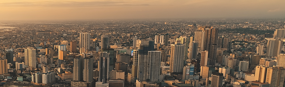 sunrise-over-cityscape-with-green-park-at-river