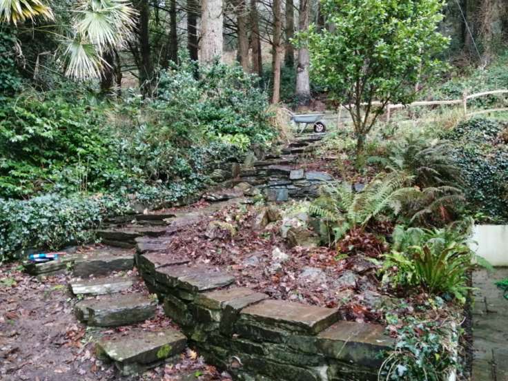 Stone steps running up side of beds through vegetation