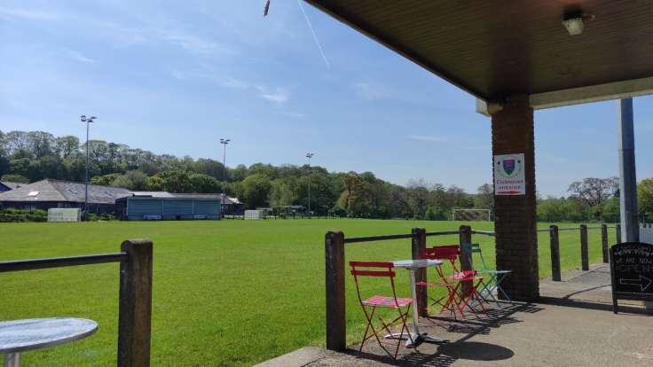 Cafe seats and overhang, overlooking a football pitch
